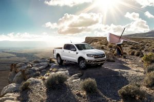 A white 2021 Ford Ranger parked on a cliff with a beautiful background of the open sky.