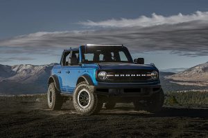 Blue 2021 Ford Bronco parked on a field.