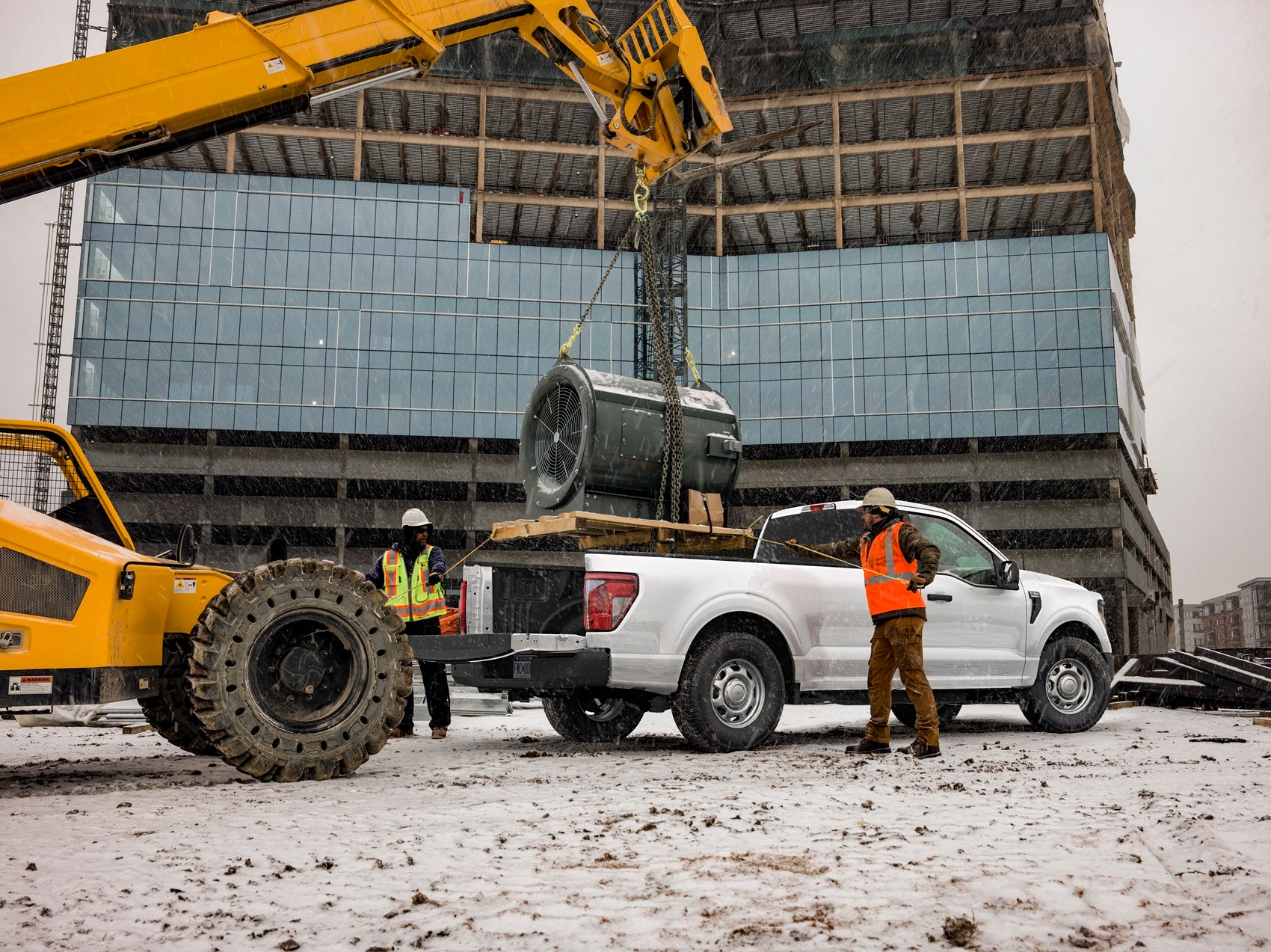 Construction Team Loading Materials in Bed of Ford Pickup Truck near Holly MI